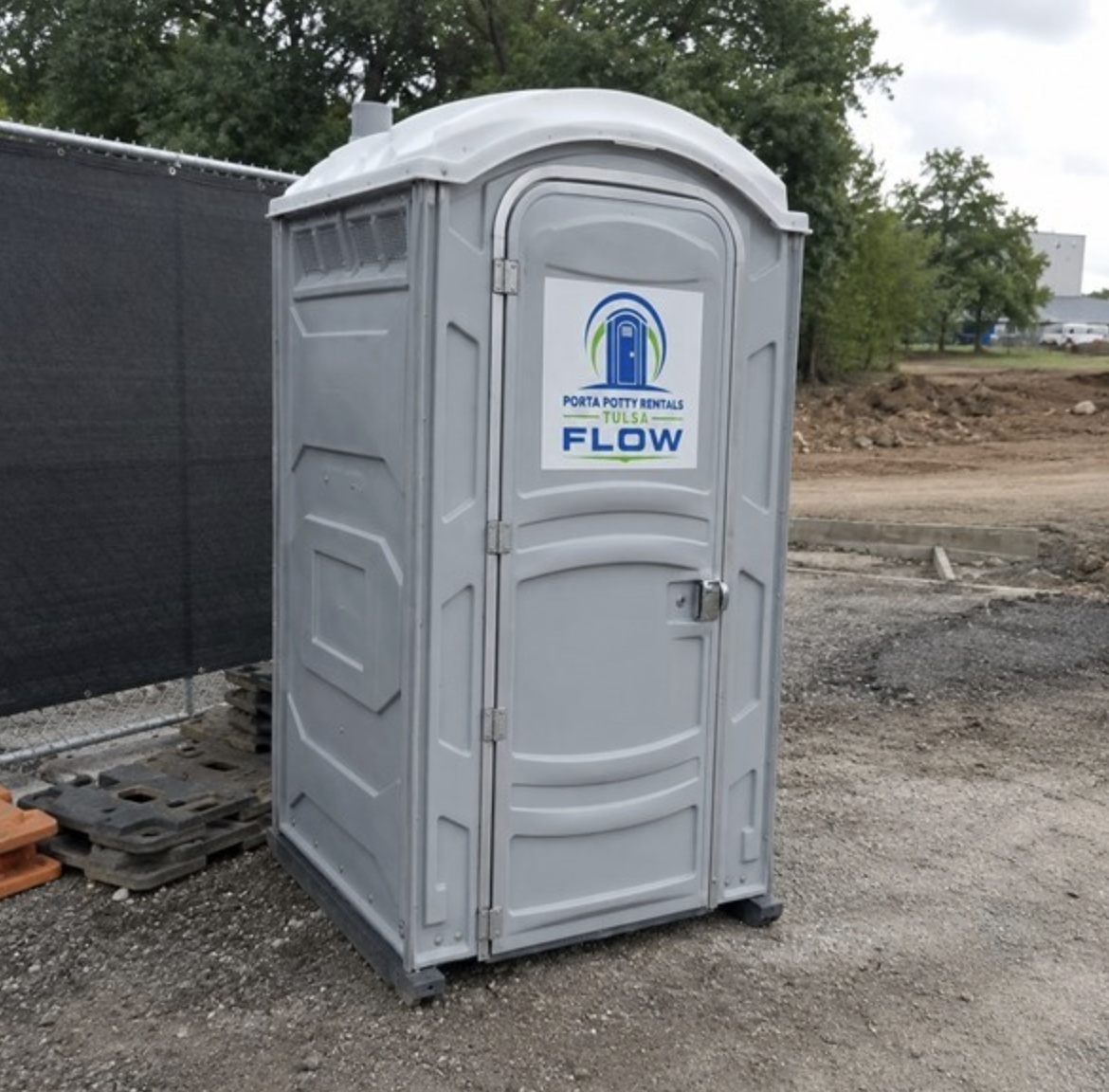 Grey porta potty at a construction site